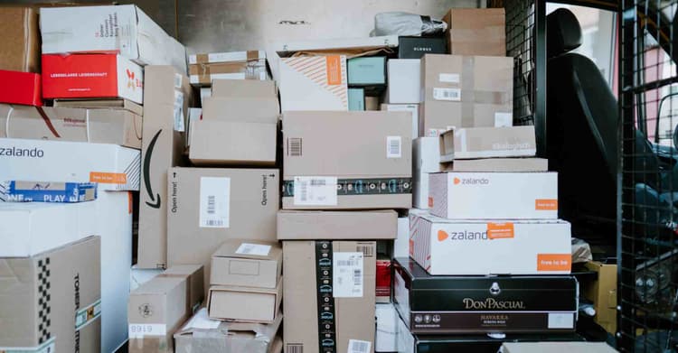 A photo of packages in the back of a truck, taken by 🇨🇭 Claudio Schwarz | @purzlbaum on Unsplash